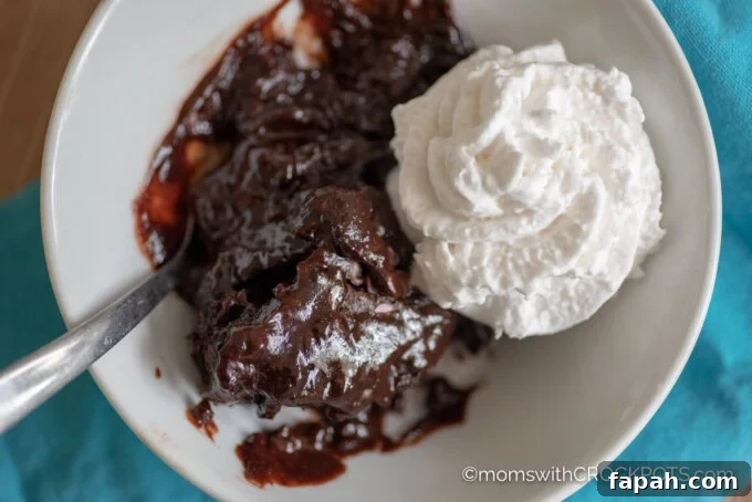 Bowl of Crockpot Chocolate Lava Cake topped with whipped cream