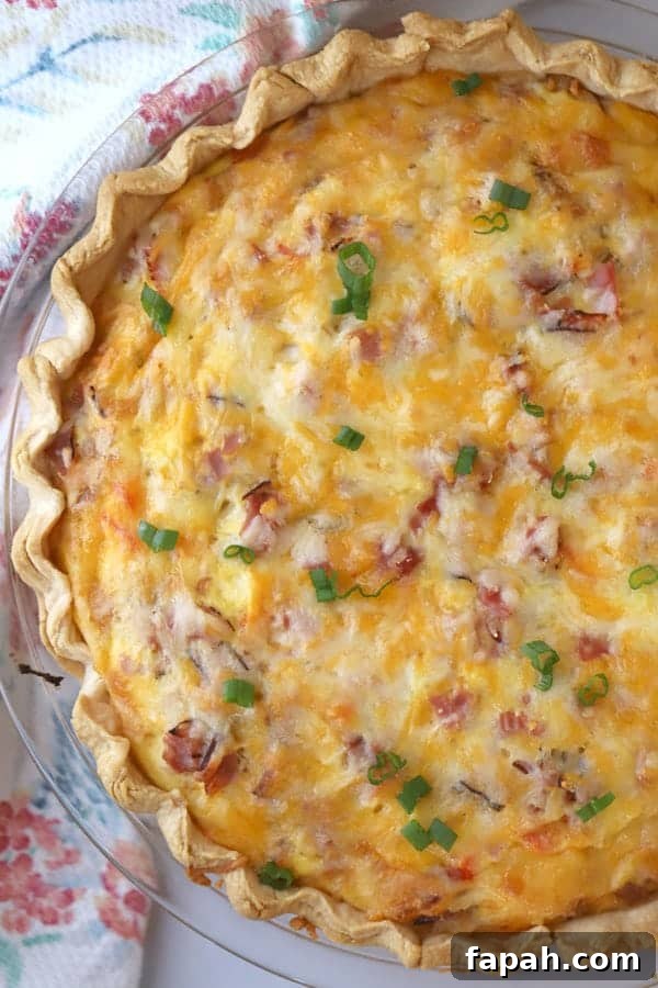 A pie plate with this ham and cheese quiche recipe in a flaky pie crust.