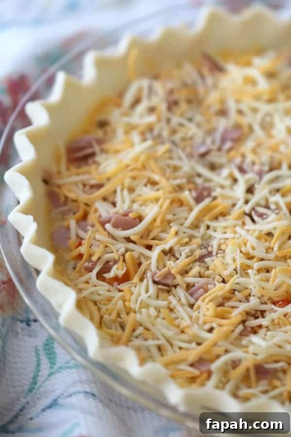 Ham and cheese in a frozen pie crust ready to add the filling and bake.