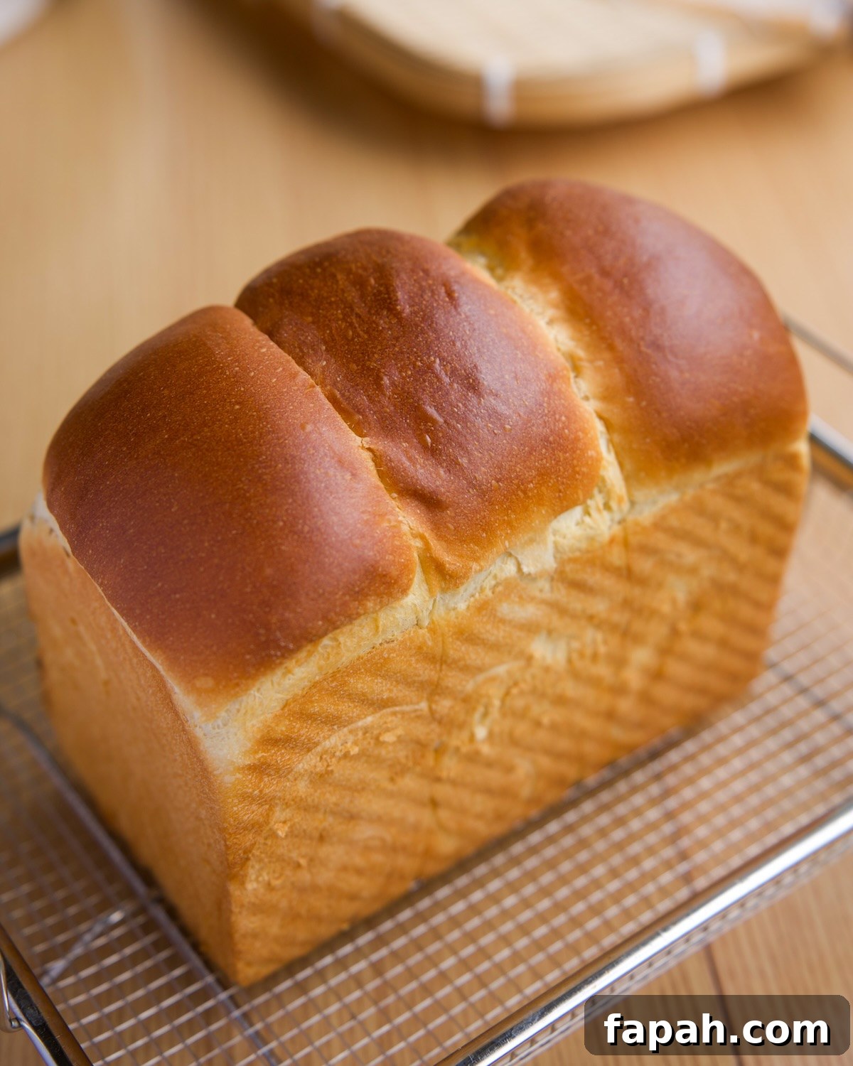 milk bread loaf cooling on a wire rack