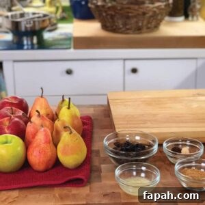 Apples, Pears, and additional ingredients on a cutting board