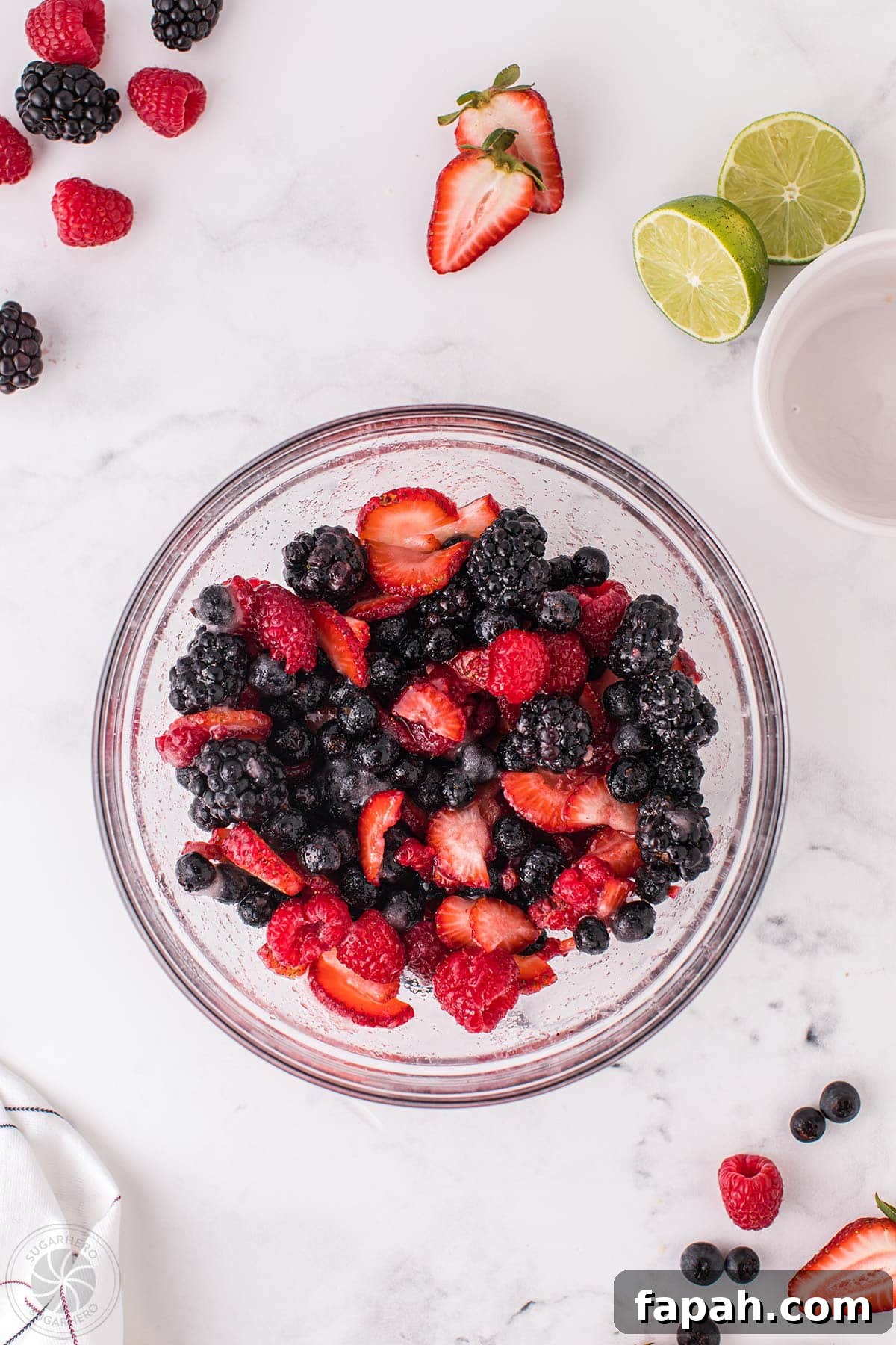 A bowl of mixed berries macerating.