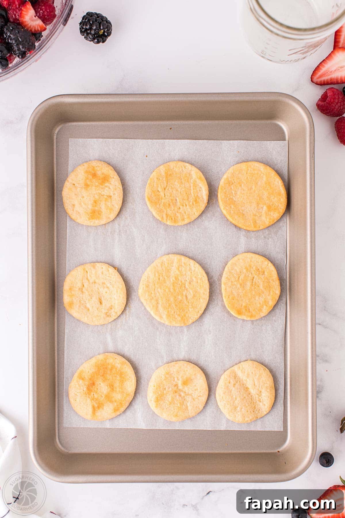 Baked crescent roll circles on a baking sheet.