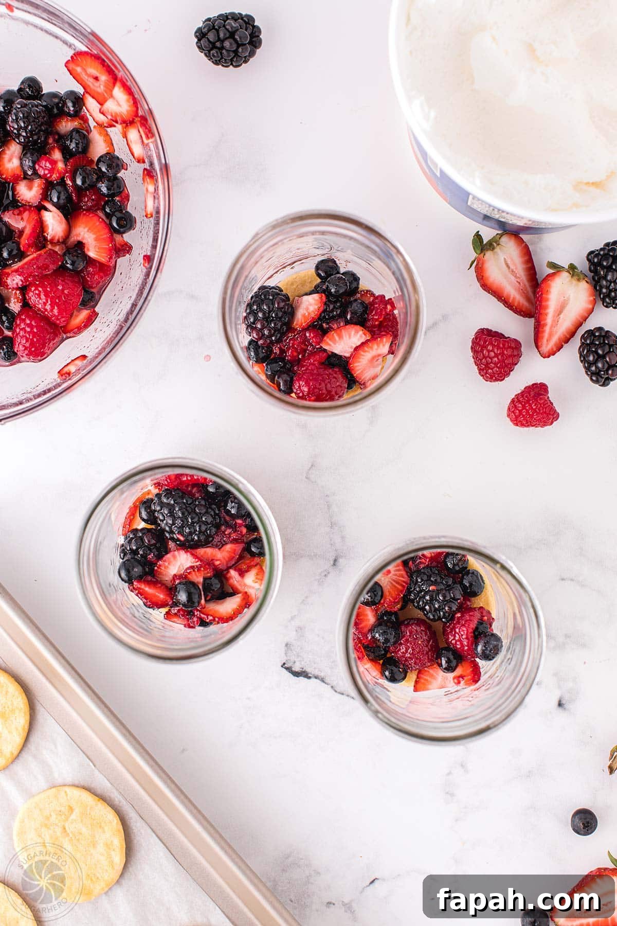 Mixed berries on top of crescent rolls in mason jars.