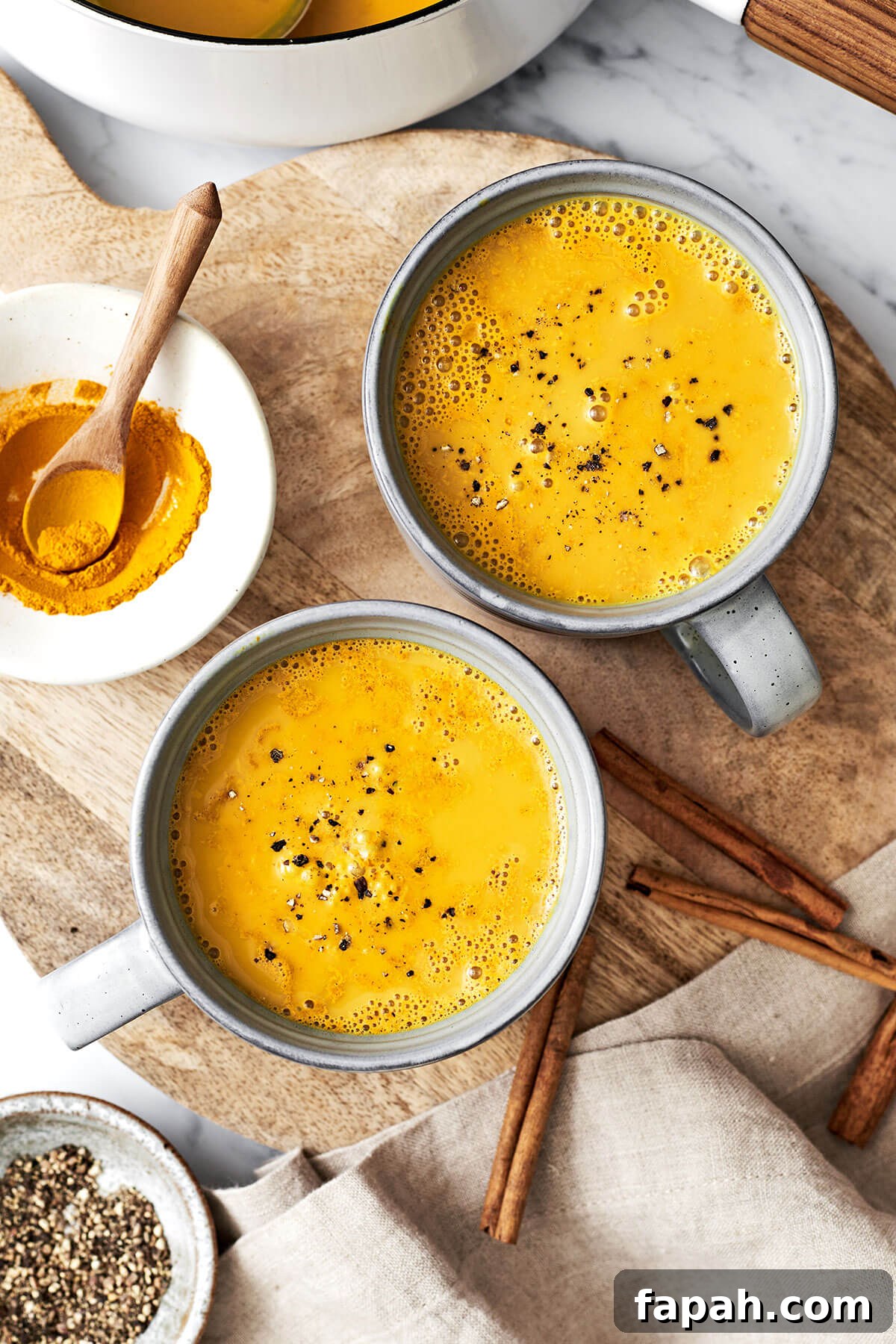Mugs of turmeric golden milk