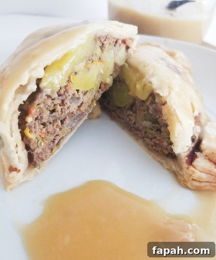 a pastie cut in half, showing the meat and veggies inside