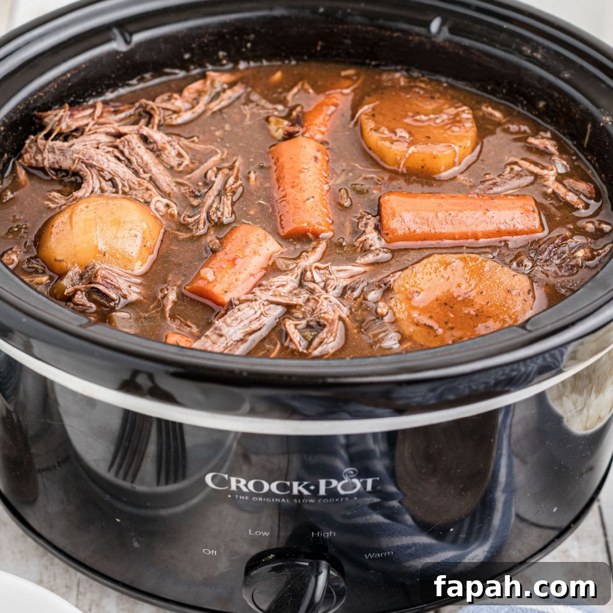 Slow cooker venison roast with red wine and carrots and potatoes.