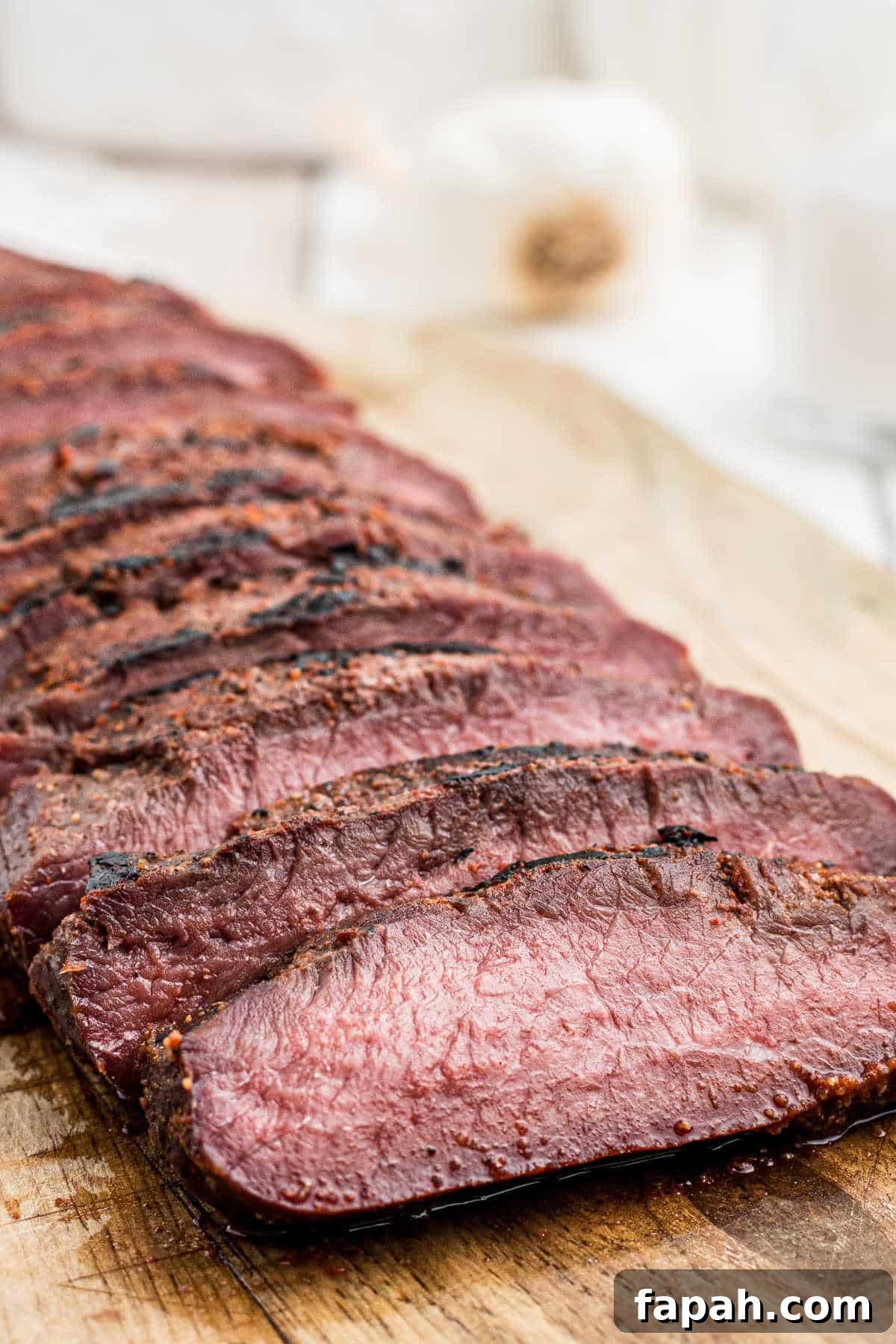 smoked venison backstrap sliced on a board
