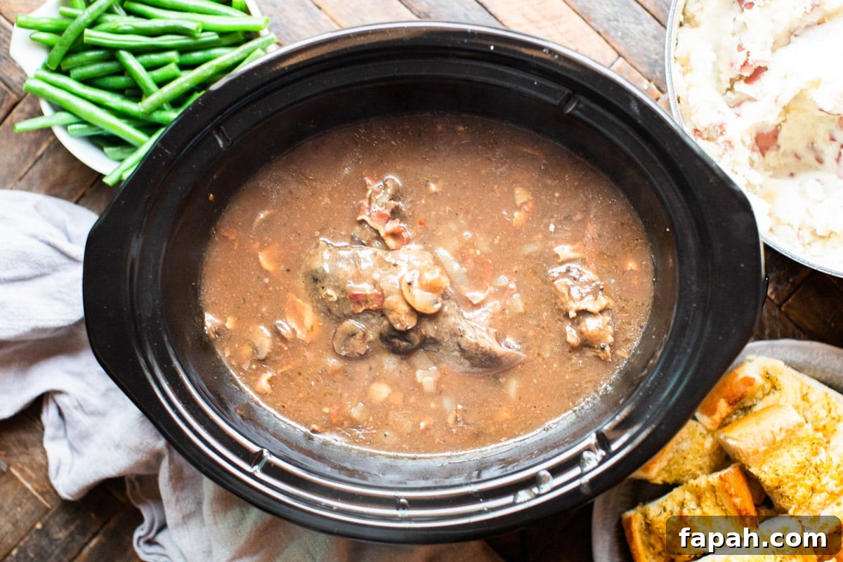 slow cooker with venison roast and mushrooms