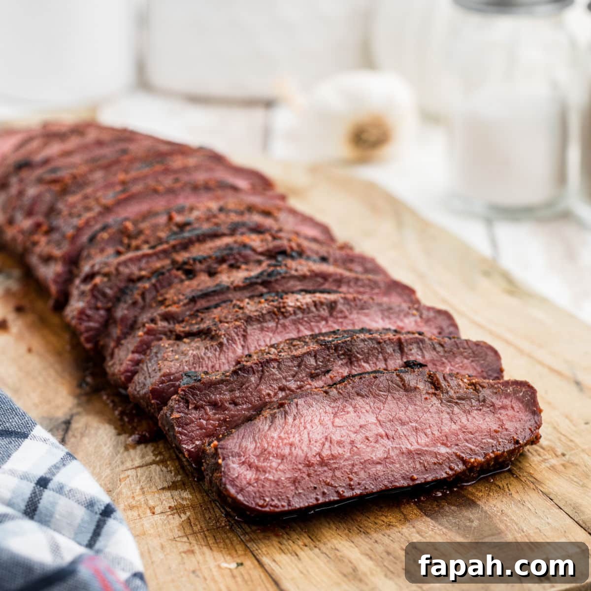 smoked venison backstrap sliced on a board