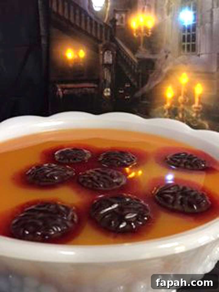 White punch bowl with melting red 'brains' floating on top