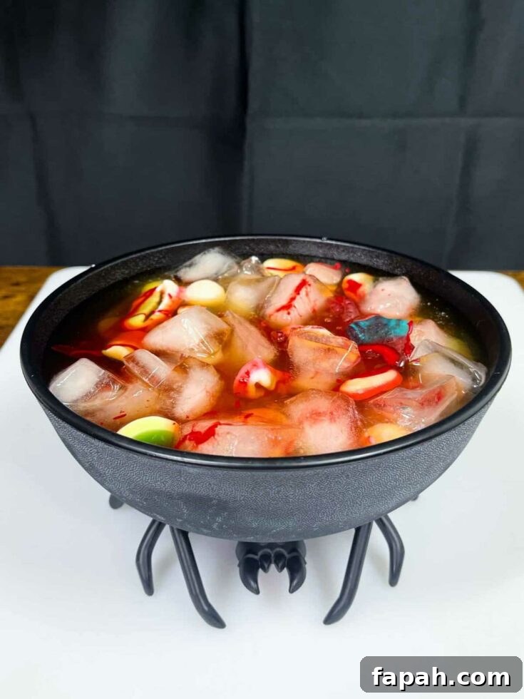 Black spider punch bowl with floating edible Halloween decorations and red 'blood' drips