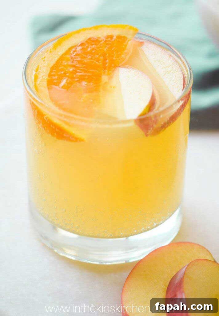 Glass of punch garnished with fruit slices