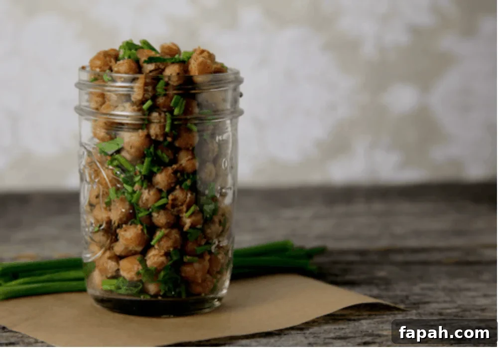 Cool Ranch Roasted Chickpeas in a jar next to some chives