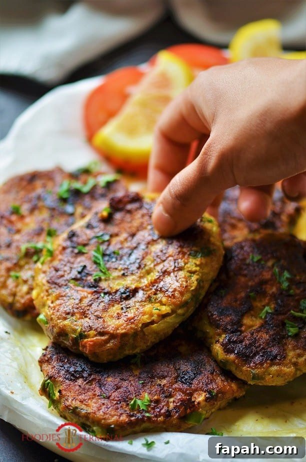 Chicken Chapli Kabab stacked together & being lifted