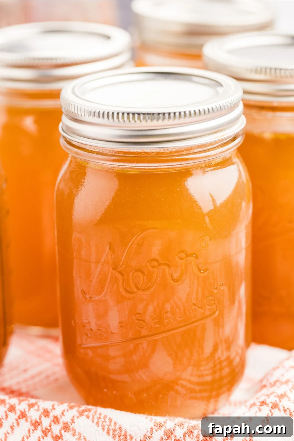 sealed mason jars of bone broth on cloth.