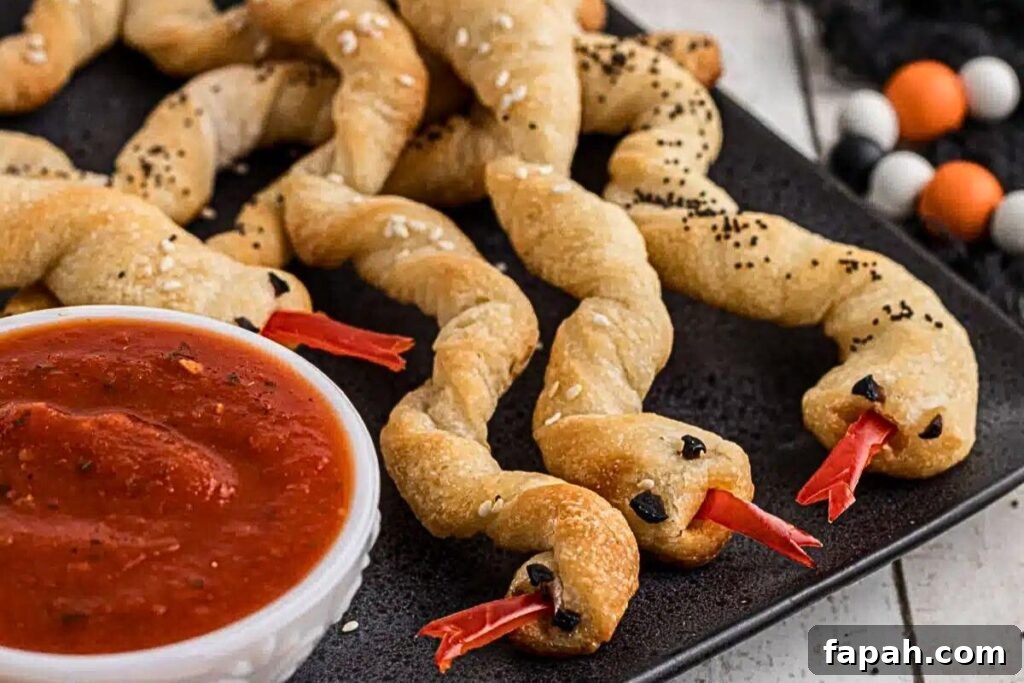 Breadsticks shaped like snakes with a pepper tongue.
